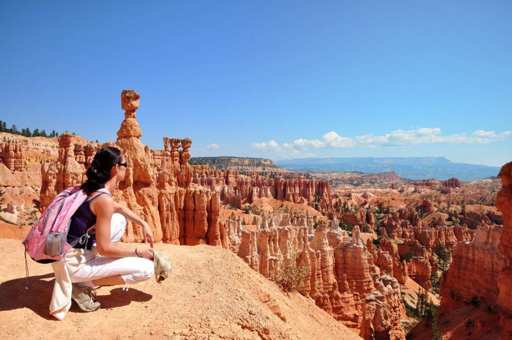 A Hiker sits a the edge of Bryce Canyon and enjoys the view