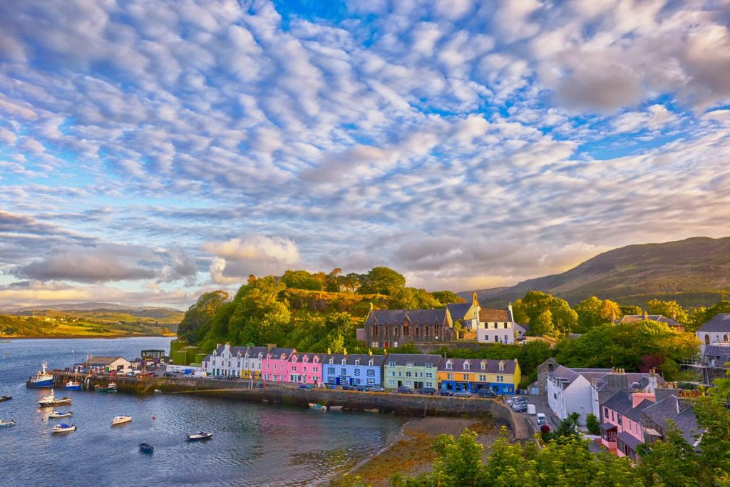 colourful buildings line the harbour in portree, skye