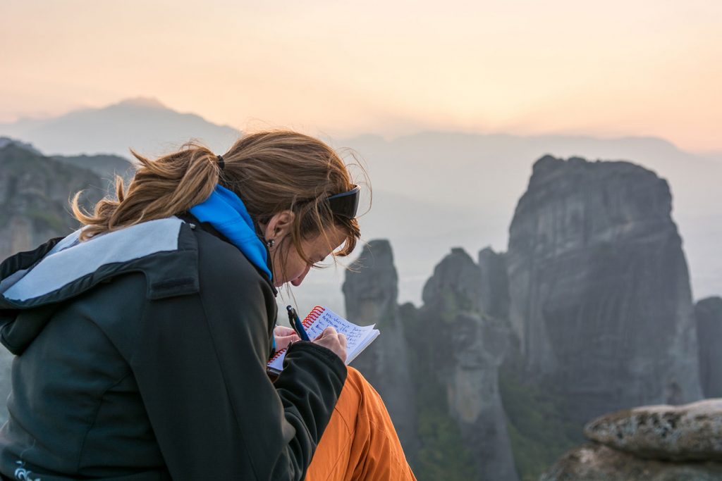 Girl writing travel journal in South America