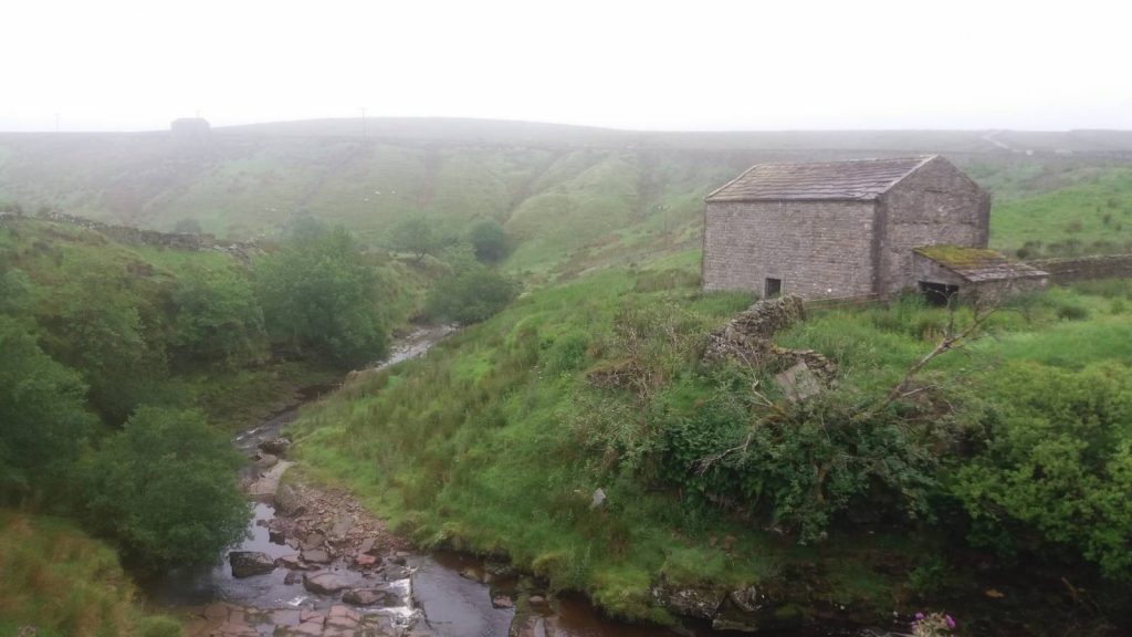 An ancient cowhouse sits in a typical Yorkshire field