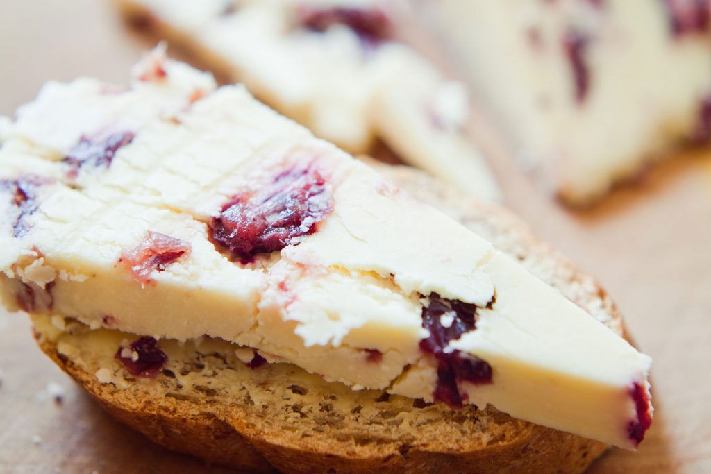 A creamy slab of Wensleydale cheese from Yorkshire sits on a slice of homemade bread