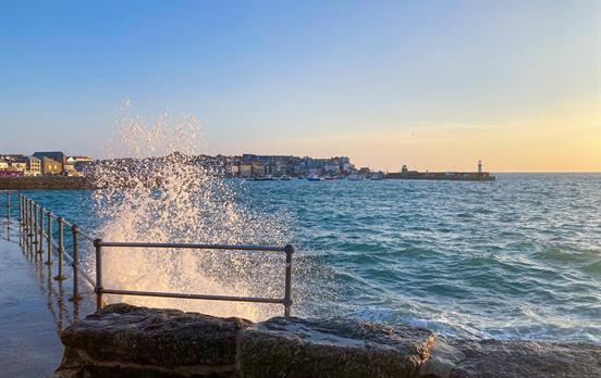 Waves crashing against the harbour