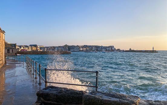 Waves crashing against the harbour