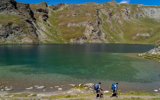 Hiking along a mountain lake in the Queyras