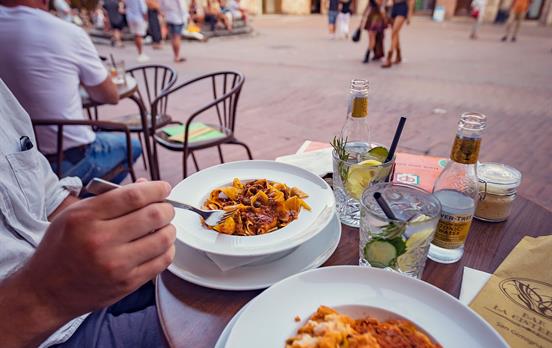 Dine on delicious pasta in a village square