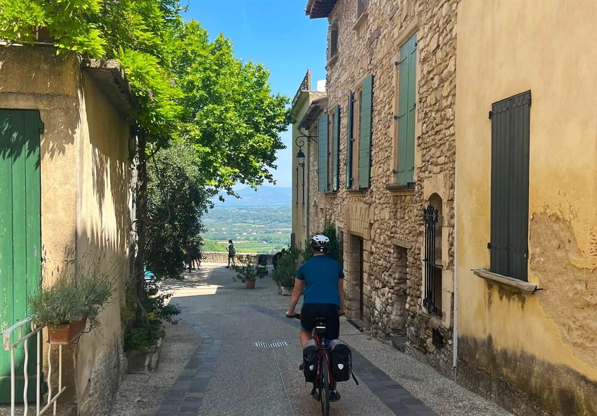 Cycling through the village of Venasque