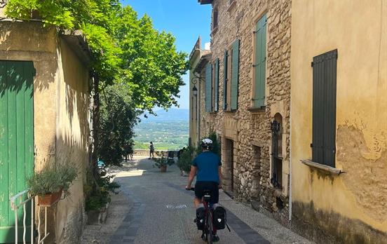 Cycling through the village of Venasque