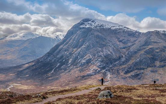 A hiker passing Buachaille Etive Mor