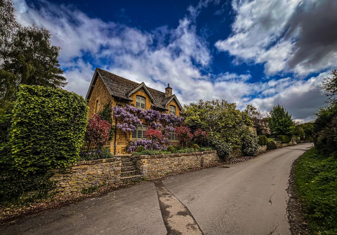 Wisteria laden limestone cottages.