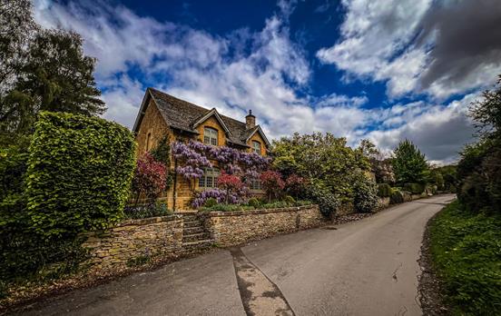 Wisteria laden limestone cottages.