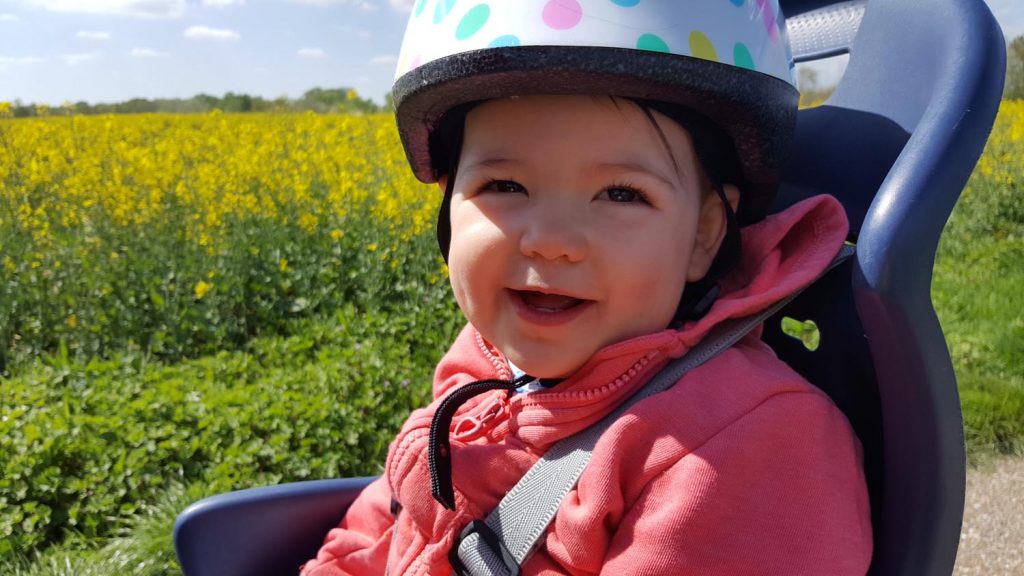 Baby with cycling helmet