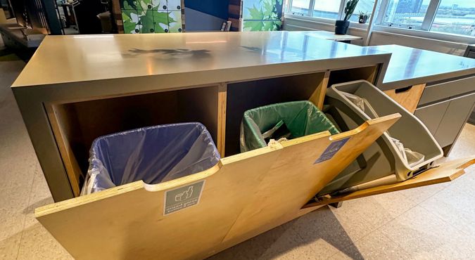 three recycling bins in an office