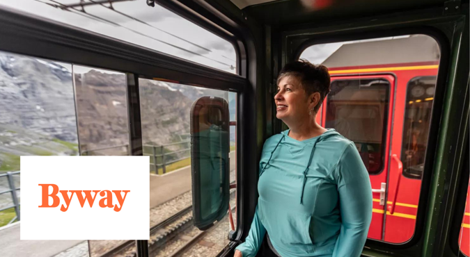 woman standing on train looking out window