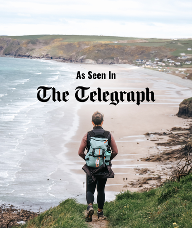 Woman looking out to beach with text on image saying 'As Seen In The Telegraph'