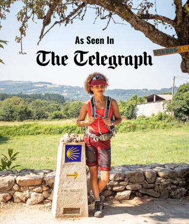 Woman standing at Camino landmark
