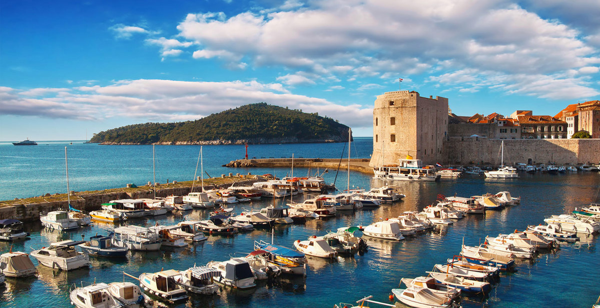 Dubrovnik old town castle and harbour full of boats