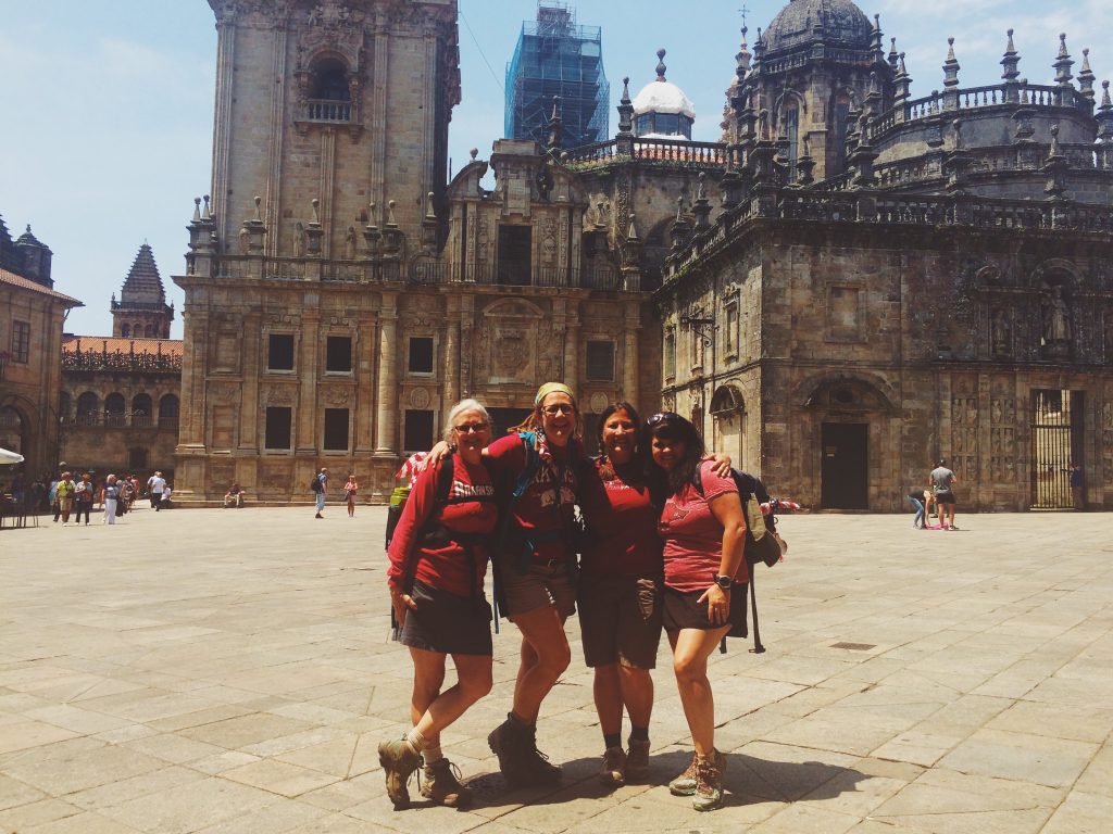 Pilgrims celebrate at the end of the Camino de Santiago